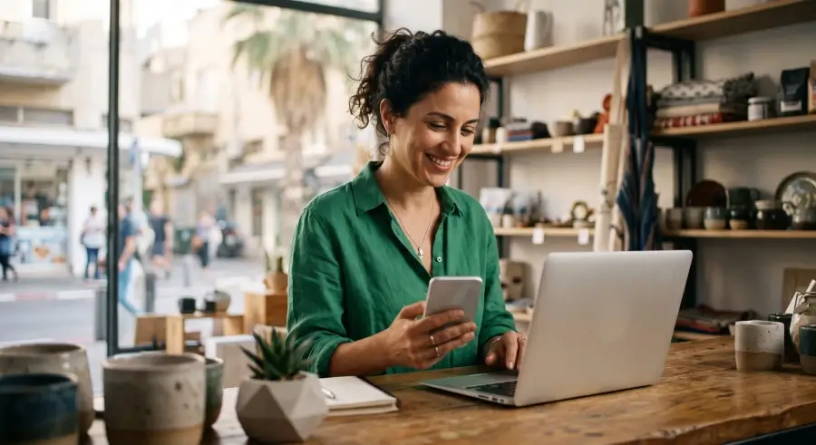 Small business owner setting up a phone system on a laptop