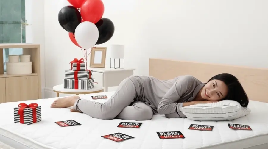 Attractive asian lady lying on a comfortable mattress she got during Black Friday